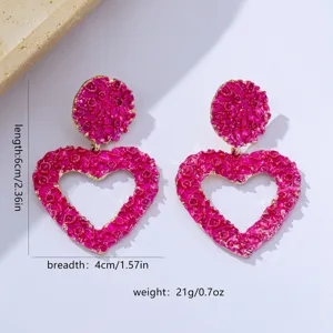 Chic pink textured heart-shaped earrings with metallic golden edges for women fashion style.