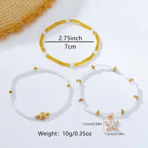 Ensemble de bracelets de perles style plage bohème avec étoiles de mer et charmes dorés.