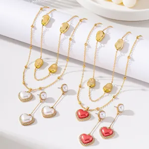 Detailed view of French vintage heart necklace and long earrings jewelry set with irregular beads.