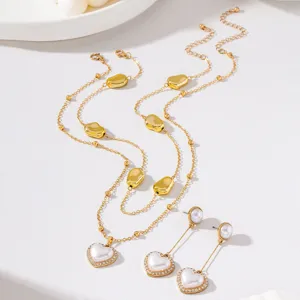 Close-up detail of the French retro gold double layer necklace and heart pearl earrings set.