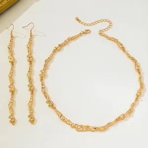Detail view of European American lava texture irregular metal necklace and long dangle earrings set.