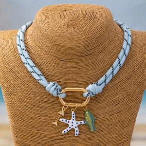 Detail shot of ocean beach style colorful rope necklace with starfish and fish pendants.