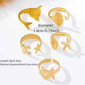 Conjunto de anillos abiertos dorados con temática marina delfín concha cangrejo para playa.