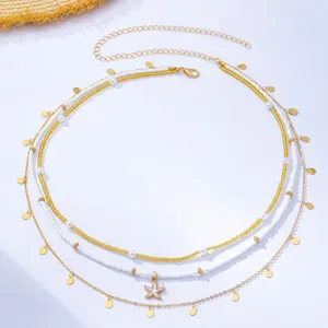 Multi-layer beach waist chain with white beads, gold chains, and starfish pendant detail.