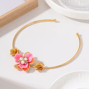 Elegant gold-tone open choker necklace featuring a 3D pink enamel flower with pearl and rhinestone accents.