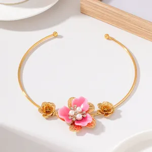 Close-up of elegant floral choker necklace featuring pink enamel flower, pearls and rhinestones.