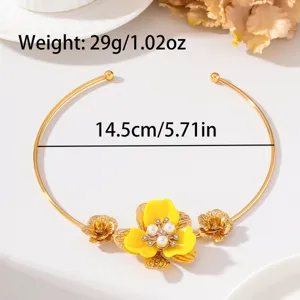 Close-up detail of gold floral choker necklace with yellow enamel, pearls and rhinestones.