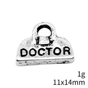 Detail shot of antique silver doctor bag charm, zinc alloy DIY jewelry accessory closeup.