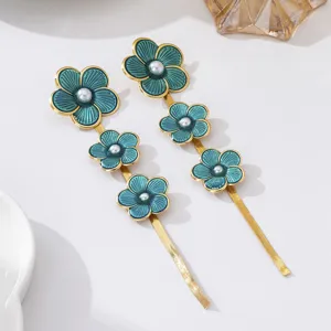 Stunning turquoise enamel floral long tassel earrings with gold finish, elegant fashion jewelry.