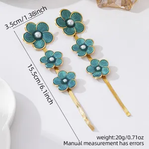 Elegant long floral earrings featuring vibrant green enamel petals, pearls and gold tone.