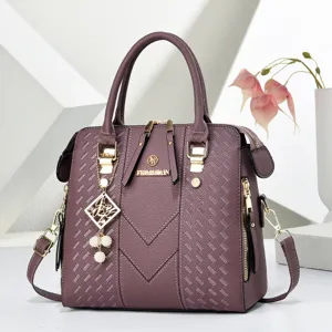 Stylish purple embossed leather handbag with chic pearl charm, perfect for daily casual wear.