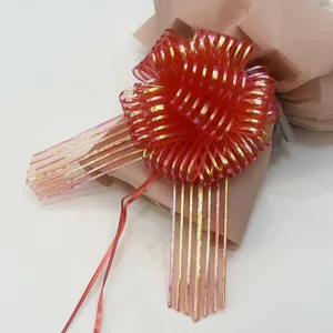 Close-up of red iridescent ribbon bow for gift wrapping, detailed mesh texture and festive decor.
