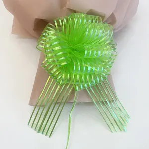 Green mesh pull bow detail for gift wrapping, vibrant ribbon flower decoration for holiday party.