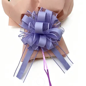 Detailed close-up of the purple decorative pull bow for holiday and Christmas gift wrapping.
