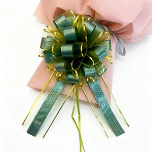 Close-up detail of green and gold tree grain gift pull bow, perfect for wedding car and decor.