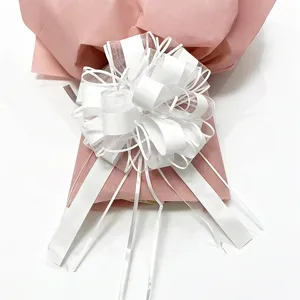 Large white decorative pull bow for gift wrapping, floral packaging, holiday party.