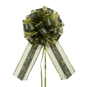 Detail view of large Christmas decorative pull bow with wood grain pattern and gold edge trim.