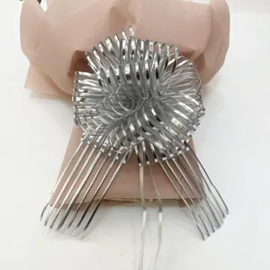 Silver tulle ribbon pull bow for Christmas holiday gift decoration, elegant 3D bowknot detail.