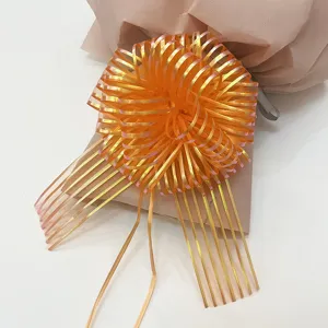 Orange decorative pull bow ribbon for Christmas gift wrapping, beautiful shiny party flower decor.