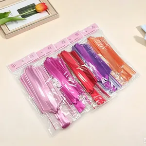Decorative pull bow for gift wrapping, vibrant colored ribbons in clear packaging for Christmas.