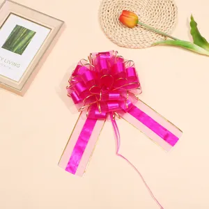Large pink gold-edged decorative pull bow for gift wrapping, wedding car, and party decor.