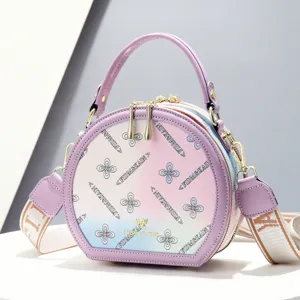 Sweet gradient round handbag for women, stylish crossbody bag with top handle and shoulder strap.