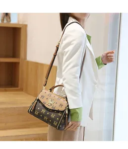 Detailed view of the stylish brown monogram shoulder bag with metallic lock and zipper accents.