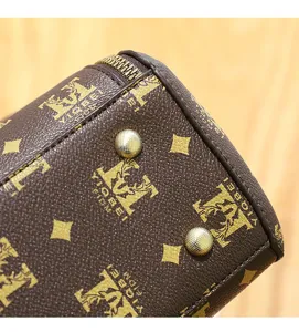 Detailed view of the vintage monogram handbag bottom, showing metal feet and zipper design.