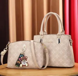 Detailed view of the stylish two-piece handbag set with monogram print and cute bear charm.