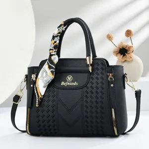 Black embossed top-handle handbag with silk scarf detail, elegant women shoulder bag.