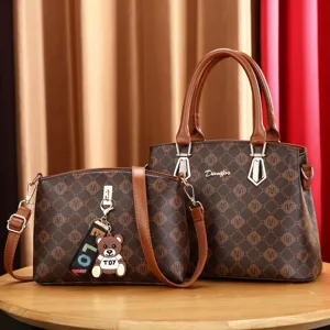 Stylish brown monogram handbag and crossbody bag set with cute bear keychain for women.