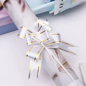 Medium white gold-edged pull bow for gift and flower wrapping, decorative holiday ribbon.