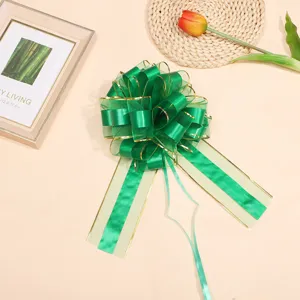 Large green ribbon bow with gold edge for Christmas gift wrapping, wedding car and floral decoration