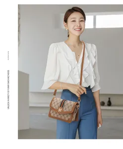 Trendy women's crossbody shoulder bag with classic monogram print and stylish strap.