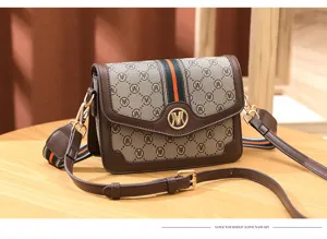 Close-up detail of stylish brown crossbody bag featuring monogram canvas and stripe.