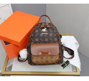 Women brown monogram backpack casual school bag with front pocket and pom pom charm