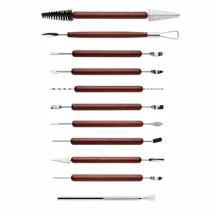 Detailed view of pottery clay sculpting tools showing precise length dimensions and wooden handles.