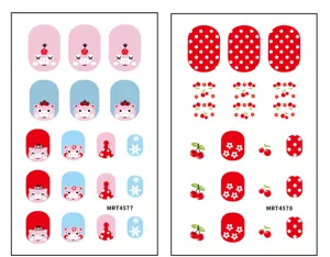 Detail view of cute cartoon pig and cherry nail sticker sheets, colorful polka dot nail art.