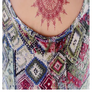 Red henna mandala temporary tattoo sticker detail shot, perfect for party body art decoration.