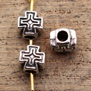 Metal cross hole bead detail view, antique silver finish, DIY jewelry making charm component.