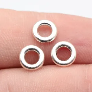 Close-up macro detail of silver round metal spacer beads, perfect jewelry finding component.