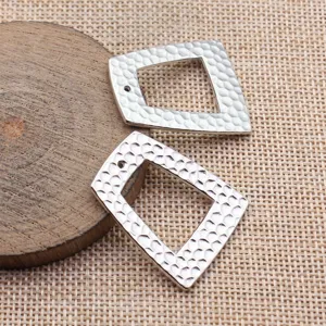 Nahaufnahme von silbernem gehämmertem geometrischem Trapez Hohl DIY Anhänger Zubehör Detail.