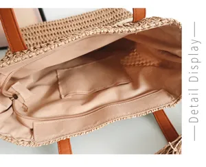 Detailansicht des Inneren einer stilvollen Strohtasche mit sicherem Reissverschlussfach.