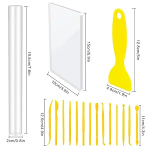 23-piece pottery tool set with acrylic rolling pin, board, scrapers, and clay carving tools.
