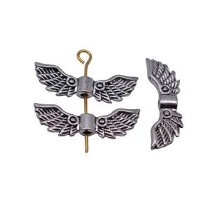 Antique silver wing bead charm detail, metal jewelry finding for DIY crafting and bracelets.