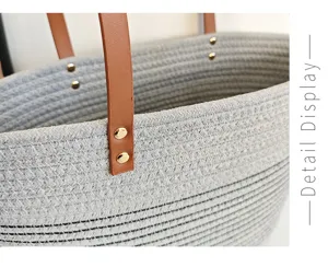 Detailaufnahme der grauen geflochtenen Tasche mit braunen Ledergriffen und stabilen Goldnieten.
