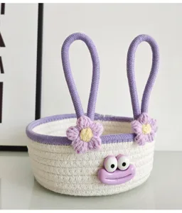 Cute cotton rope woven storage basket with cartoon frog face and crochet flower decor.