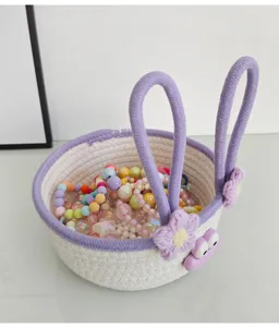 Cute woven storage basket close-up detail showing rabbit ears and colorful beads inside.