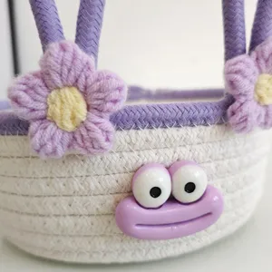 Cute woven storage basket desktop organizer with cute floral and cartoon face decor for home.
