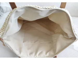 Strohtasche Innendetail, Beigefarbenes Futter mit Innentasche und praktischem Reißverschluss.